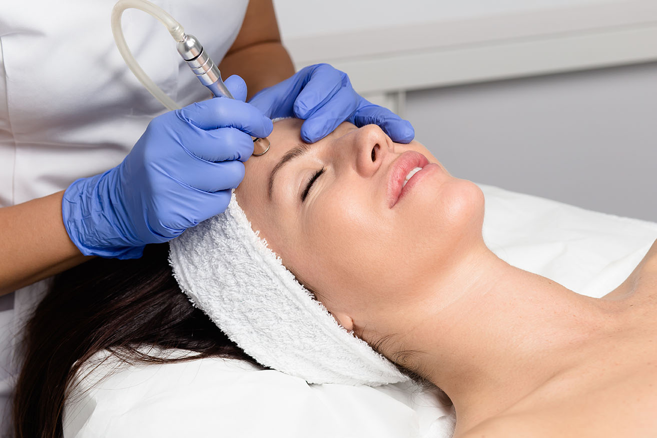 Esthetician giving microdermabrasion