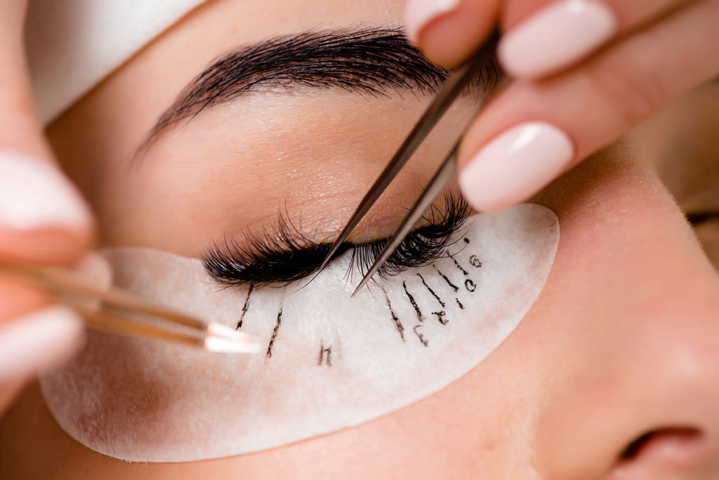 Esthetician performing eyelash extensions