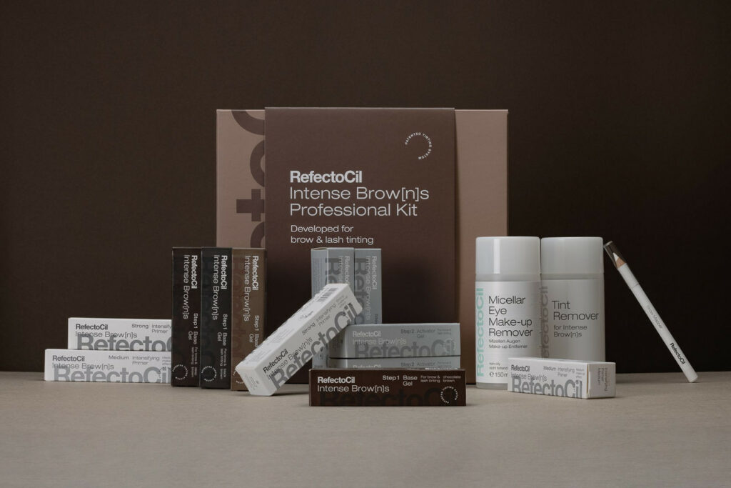 Professional eyebrow and lash lift tinting kit by refectocil, including multiple bottles and boxes, displayed on a brown background.